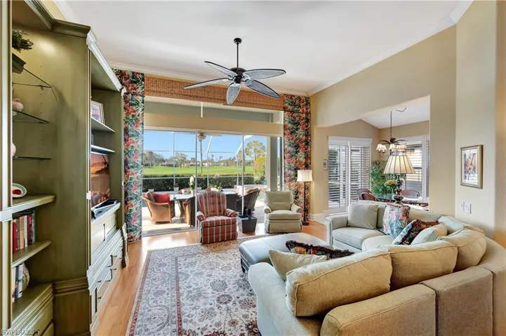 Living room featuring crown molding, plenty of natural light.