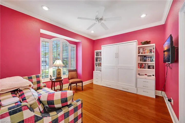 Sitting room featuring ceiling fan, ornamental molding, and hardwood / wood-style floors