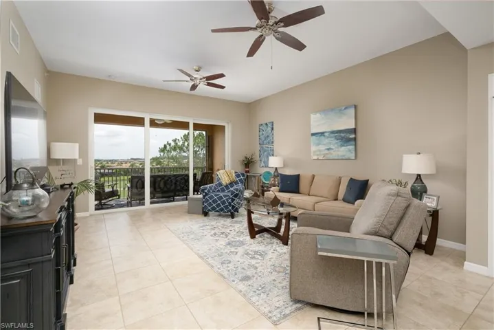 Living room featuring ceiling fan and light tile patterned floors