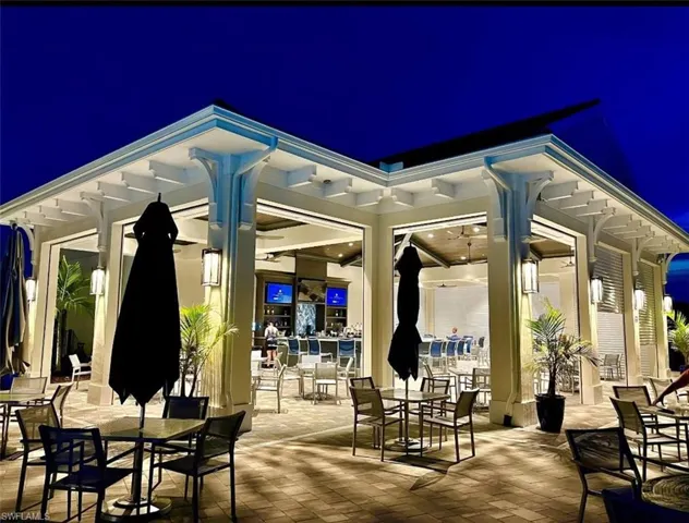 Patio at night with a patio area and outdoor dining area