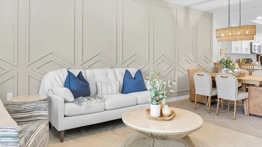 Living area with a decorative wall and tile patterned flooring