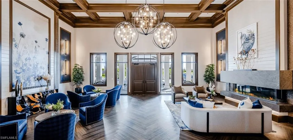 Community lobby with a towering ceiling, coffered ceiling, and beam ceiling