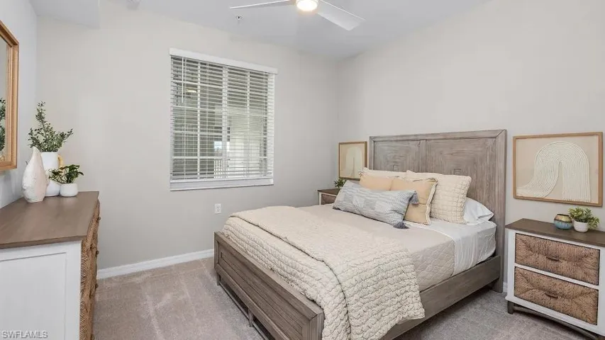Bedroom with light carpet and a ceiling fan