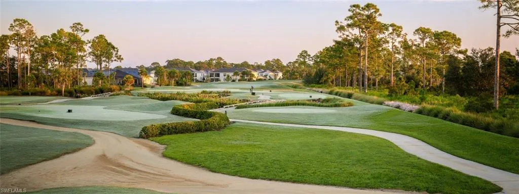 View of property's community with golf course view, a residential view, and view of scattered trees