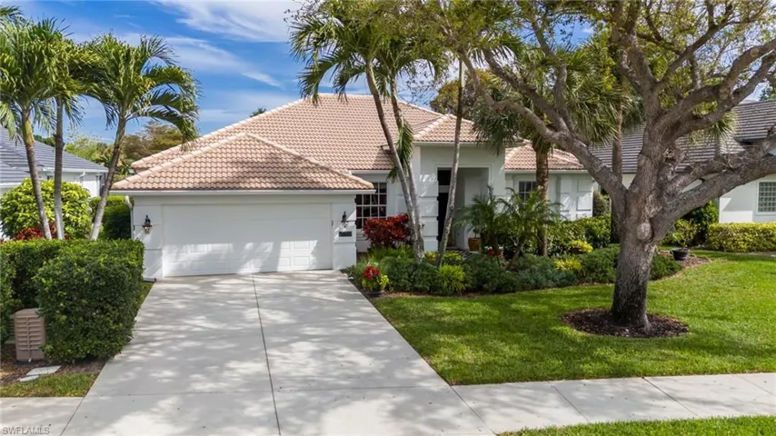 View of front of home featuring a tile roof, stucco siding, concrete driveway, and an attached garage