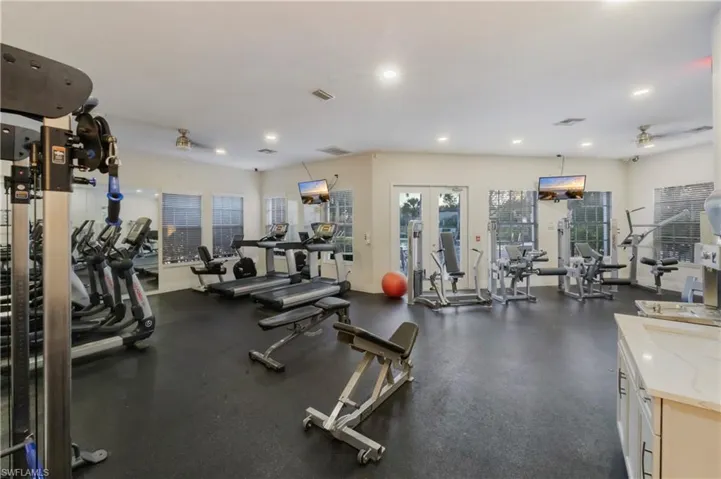 Workout area featuring a ceiling fan and recessed lighting