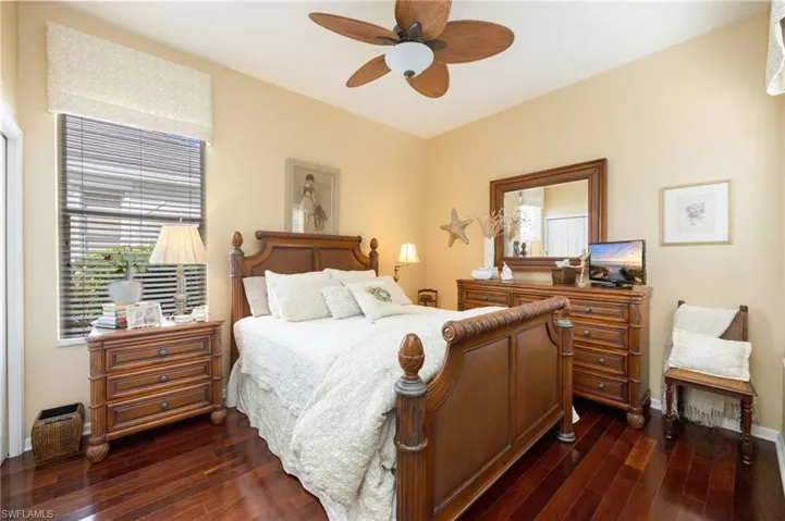 Bedroom with dark wood-style flooring and ceiling fan
