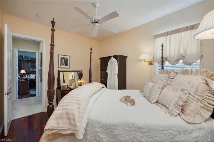 Bedroom with ceiling fan and dark wood-style floors