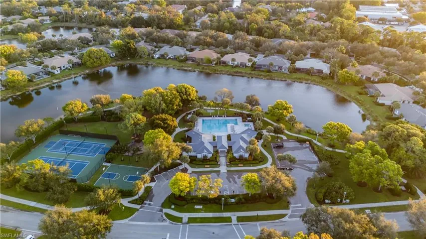 Aerial perspective of suburban area featuring a nearby body of water