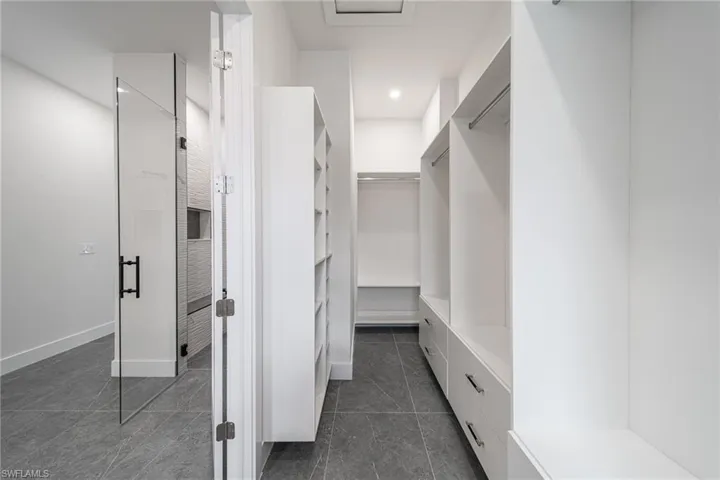 Spacious closet with dark tile patterned flooring