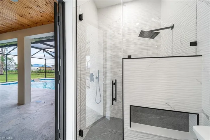 Bathroom featuring an enclosed shower and wood ceiling