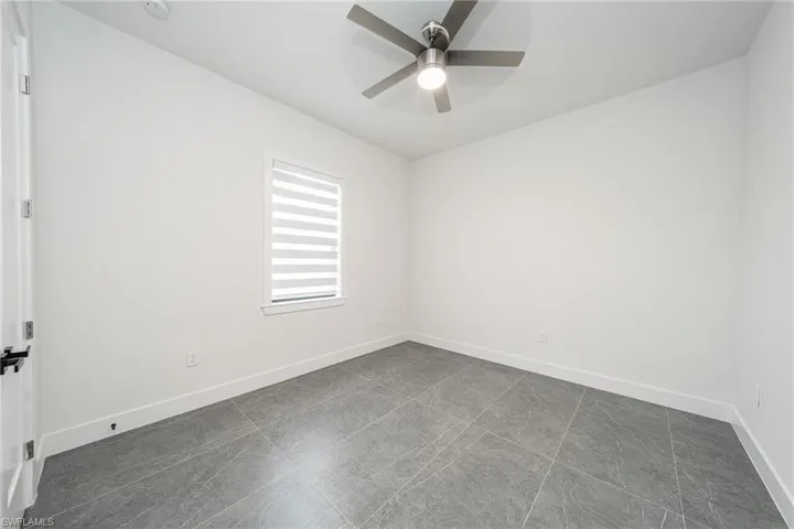 Empty room featuring ceiling fan