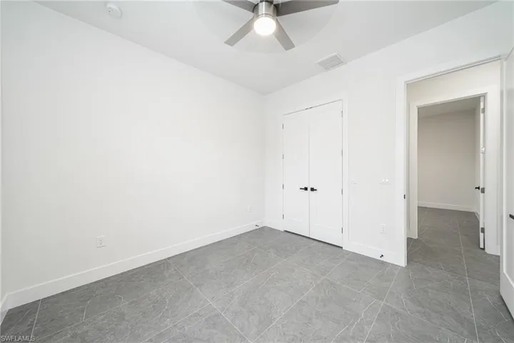 Unfurnished bedroom featuring a closet and ceiling fan