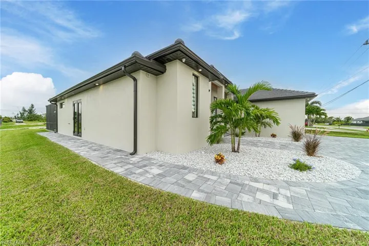 View of property exterior with a yard