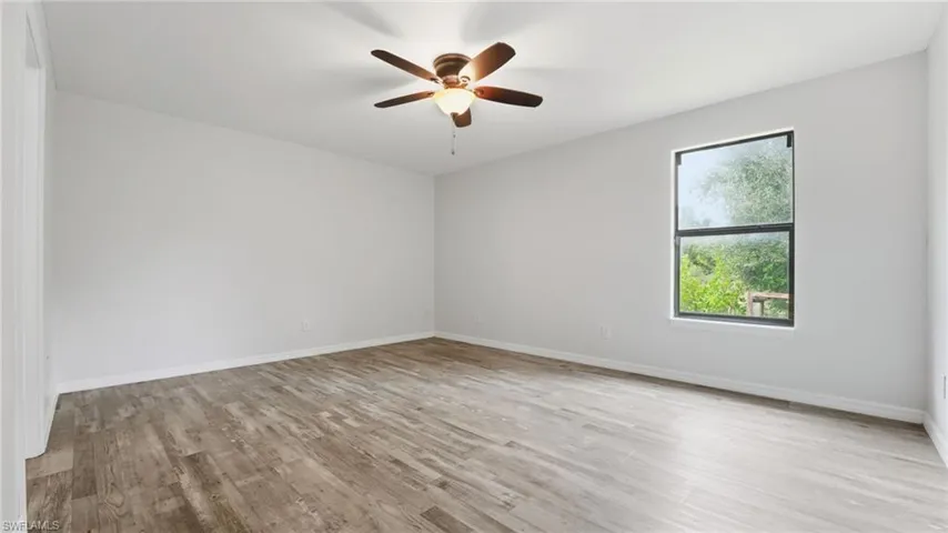 Spare room featuring light wood-style flooring and ceiling fan