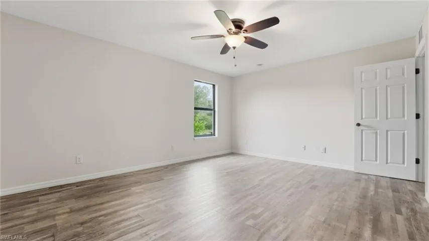 Spare room featuring light wood finished floors and ceiling fan
