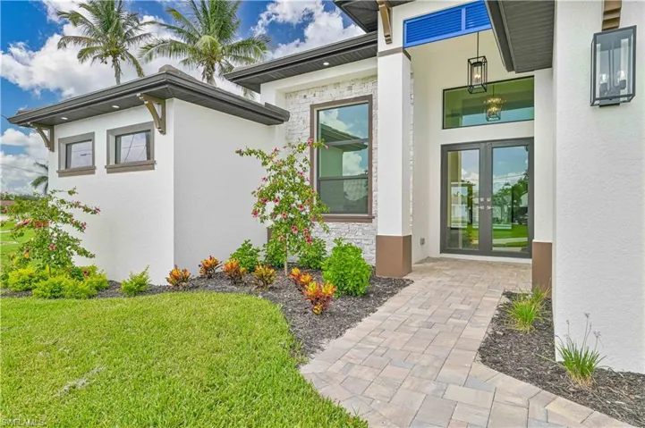 View of exterior entry with a yard