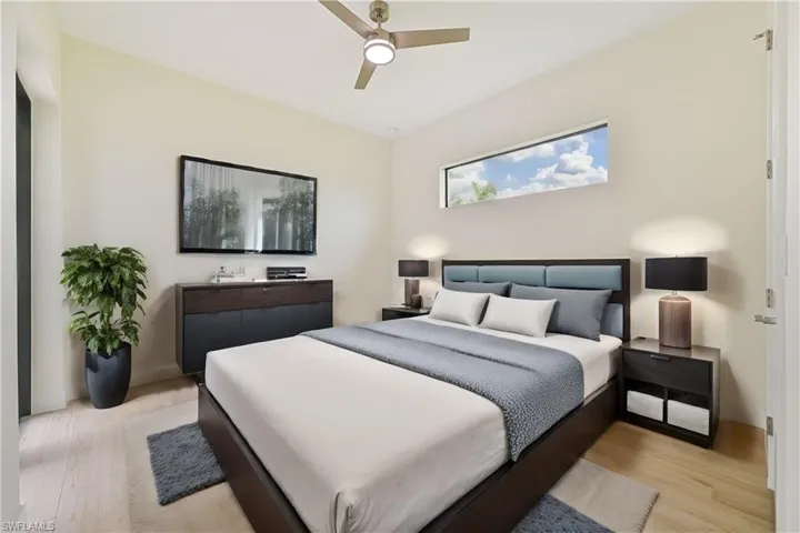 Bedroom 2 - Bedroom with ceiling fan and light. hardwood / wood-style flooring - Virtual Staged Room