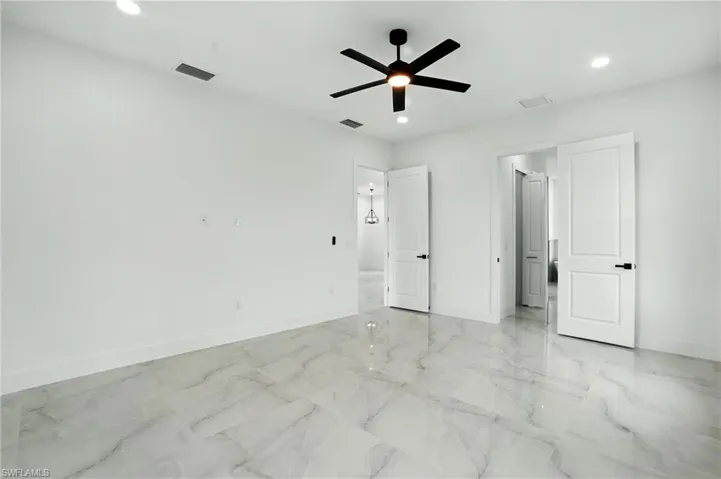 Full bath featuring a marble finish shower, a soaking tub, light marble finish floors, double vanity, and recessed lighting