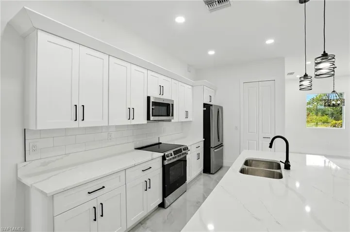 Unfurnished bedroom featuring light marble finish floors, ceiling fan, and a closet