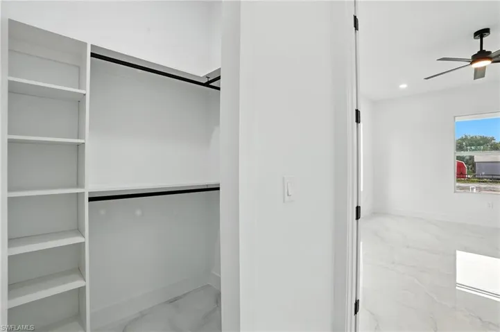 Unfurnished living room featuring recessed lighting, light marble finish flooring, and ceiling fan