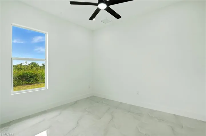 Unfurnished room with light marble finish floors, recessed lighting, and ceiling fan