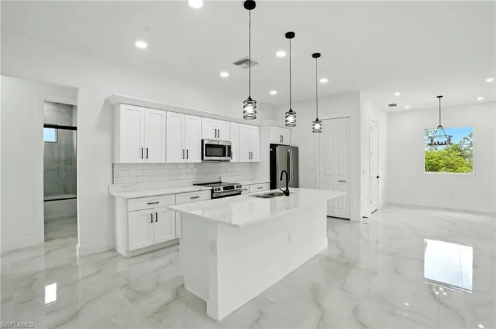 Spacious closet with light marble finish flooring and a ceiling fan
