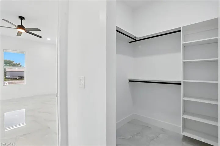 Empty room featuring light marble finish floors, recessed lighting, and ceiling fan