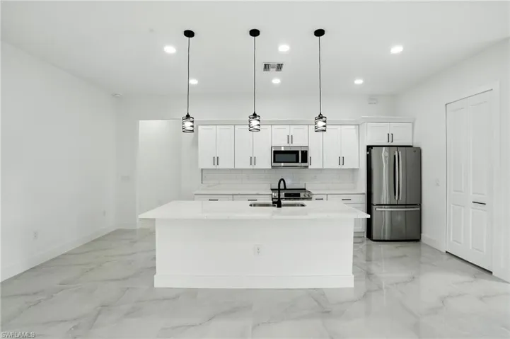 Spare room with light marble finish flooring and ceiling fan