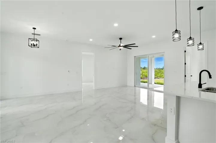 Unfurnished bedroom with recessed lighting, light marble finish floors, and a ceiling fan