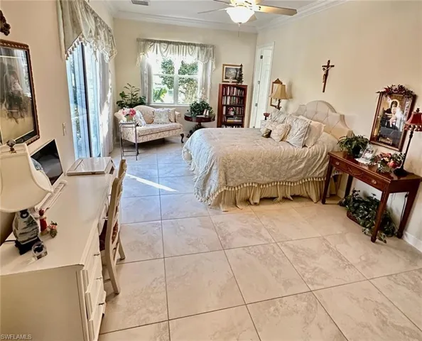 Bedroom featuring crown molding, access to exterior, and a ceiling fan