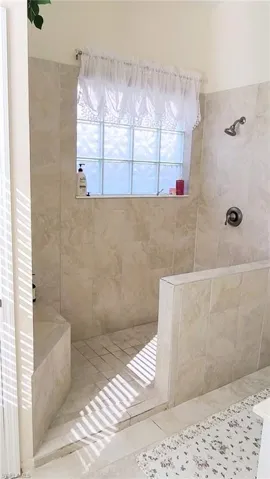 Full bath featuring a walk in shower and tile patterned flooring