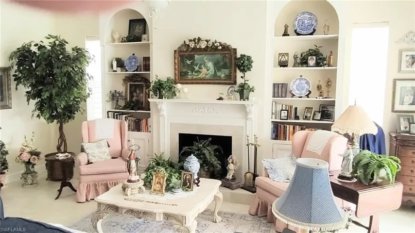 Sitting room featuring built in shelves and a fireplace