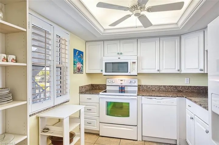 Kitchen featuring white appliances, white cabinetry, a ceiling fan, ornamental molding, and open shelves