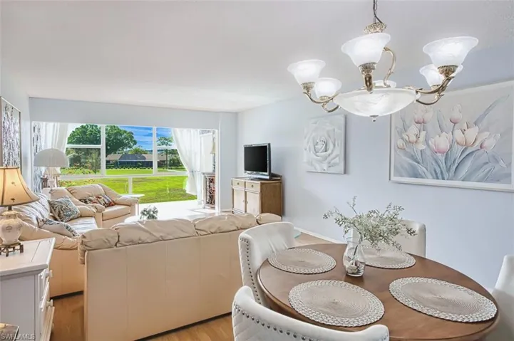 Dining area with light wood finished floors and a chandelier