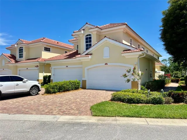 Mediterranean styled coach home featuring a two car garage