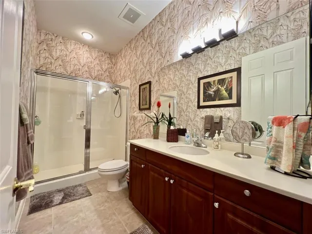 Guest Bathroom with tile flooring, walk in shower