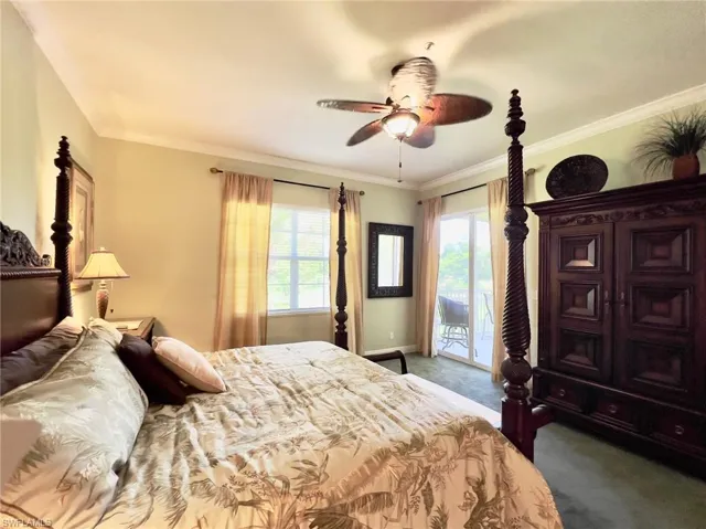 Bedroom with carpet, ceiling fan, access to screened lanai