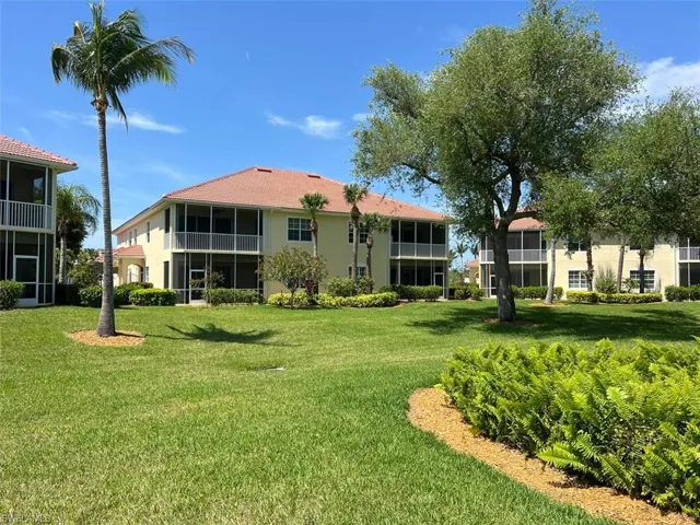 Rear view of house with a yard