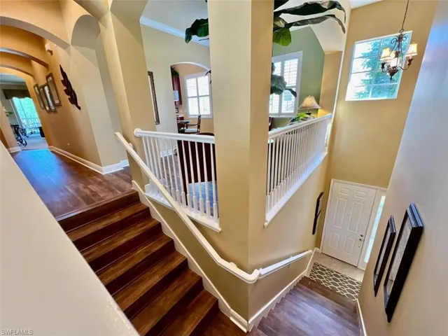 Staircase entry foyer with a chandelier, and a high ceiling