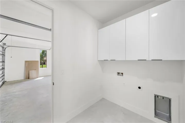 Laundry area with cabinets, electric dryer hookup, and hookup for a washing machine