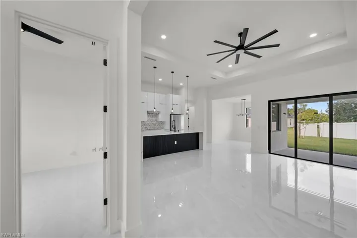Hall featuring a tray ceiling