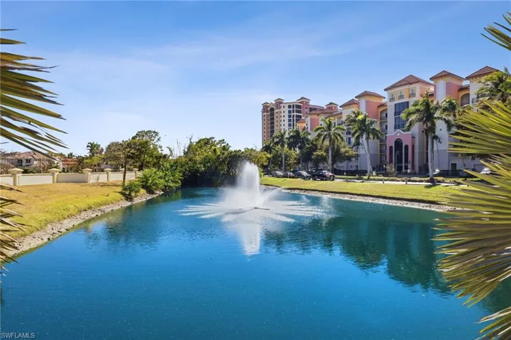 View of swimming pool featuring a water view, a yard, and a swimming pool