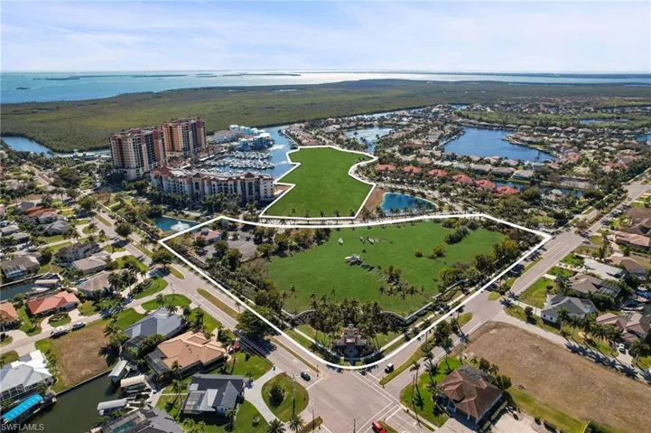 Aerial view of property's location with nearby suburban area and property parcel outlined