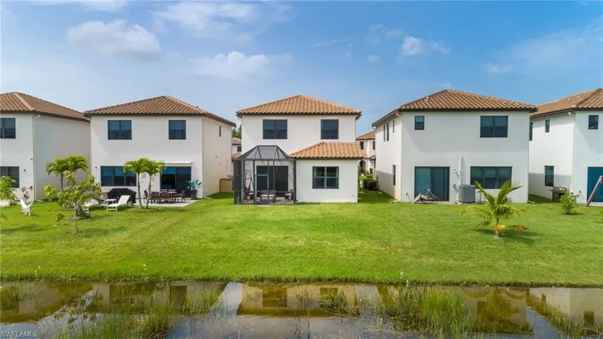 Rear view of property featuring a gazebo, a lawn, and a patio area