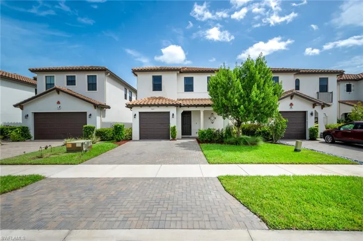 Mediterranean / spanish home featuring a front yard and a garage