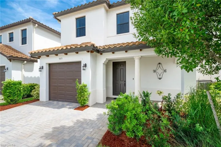 Mediterranean / spanish home featuring a garage