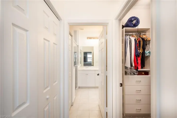 Hall featuring light tile patterned floors and sink