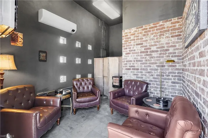 Sitting room featuring a mini split for heating / cooling and a high ceiling