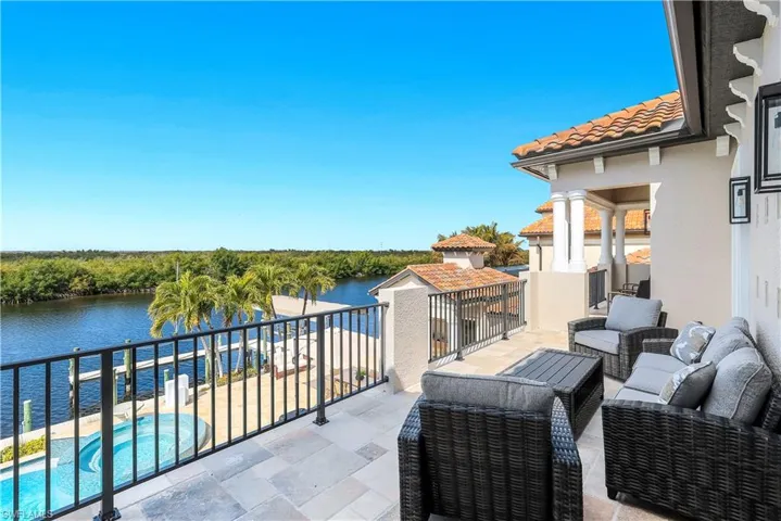 View of patio / terrace featuring a water view, an outdoor lounge area, and a jacuzzi